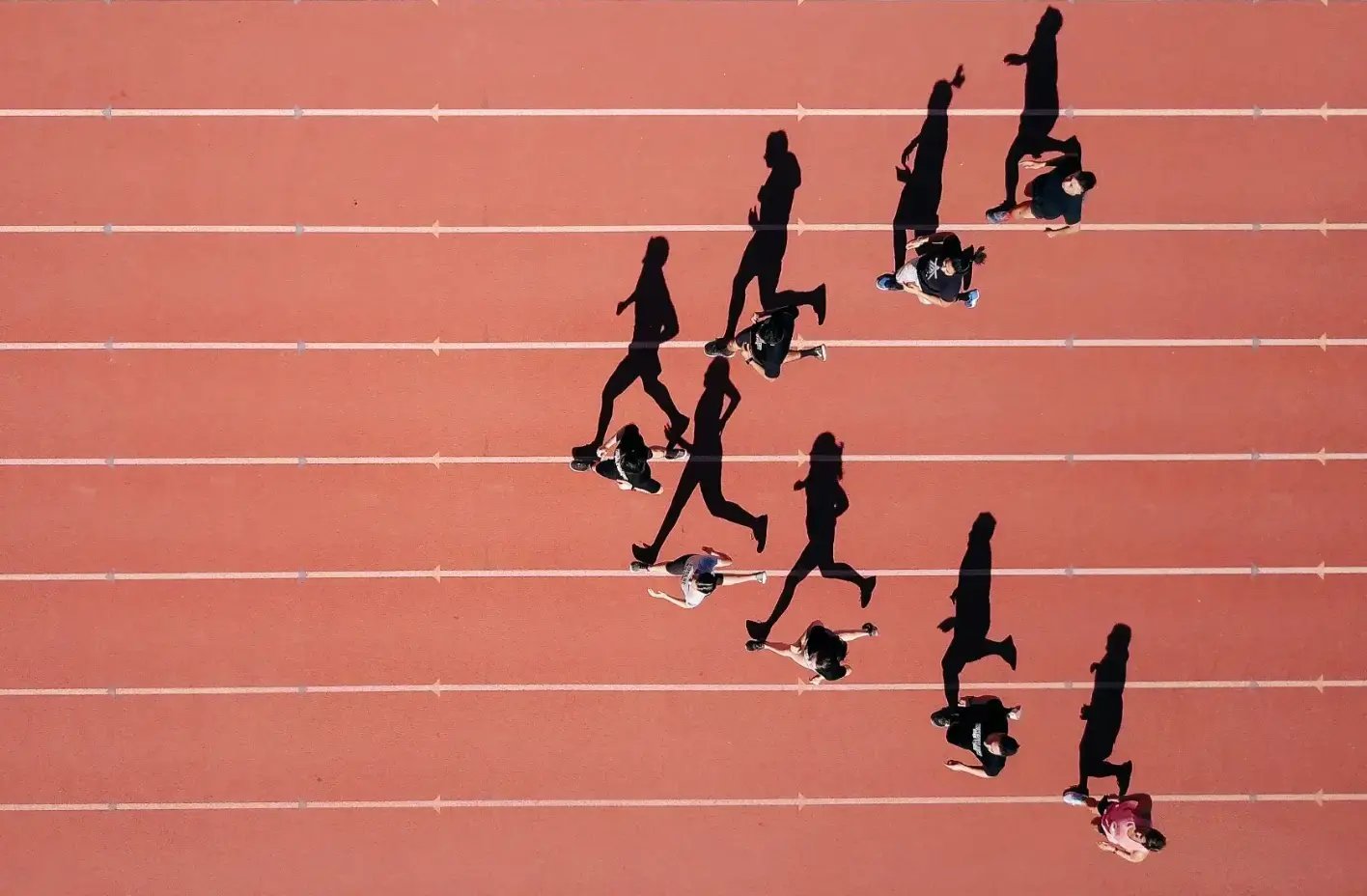 Aerial view of athletes running on a track Aerial view of athletes running on a track
